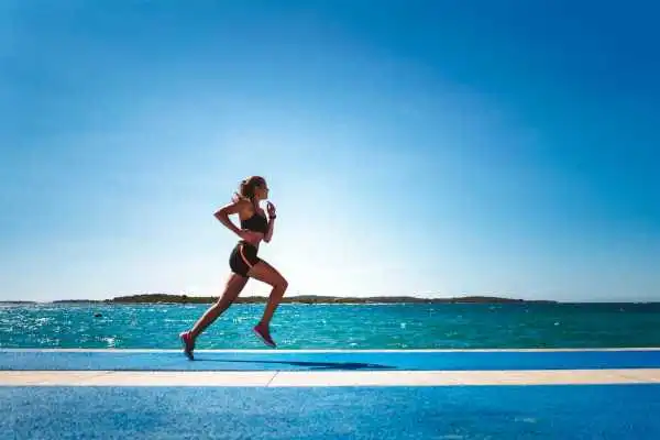 Woman running showing strong leg muscle Cannock